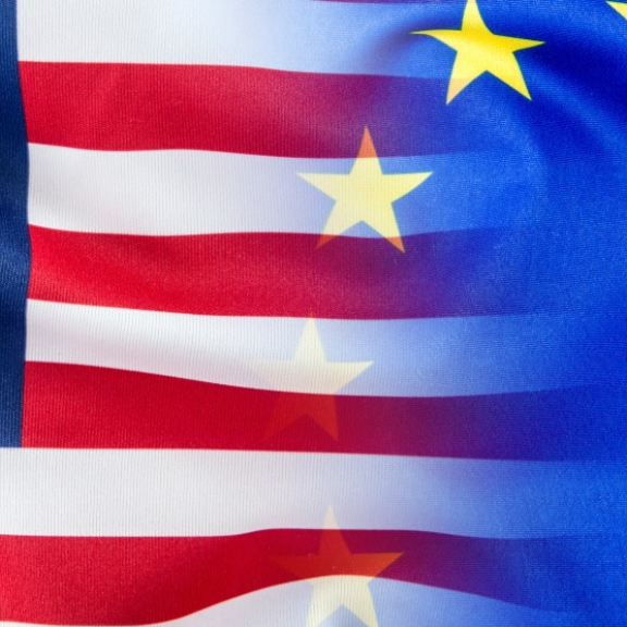 Kombination der Flaggen von USA und EU, die fließend ineinander übergehen.